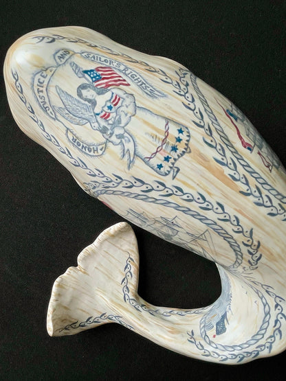 Sperm whale sculpture with hand-painted scrimshaw design.  American maritime art.