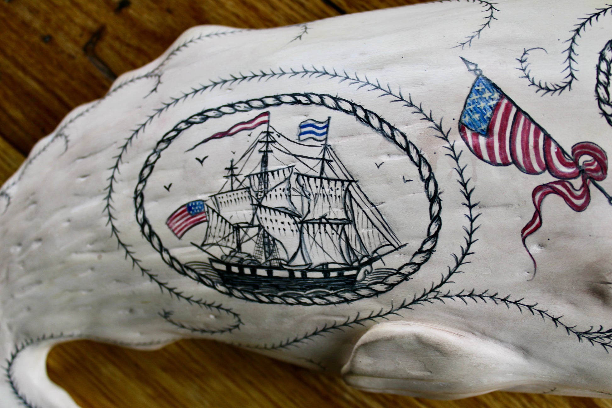 Hanging Sperm Whale Sculpture with scrimshaw designs including ships, whaling scenes, marine art, maritime art, folk art, Americana art
