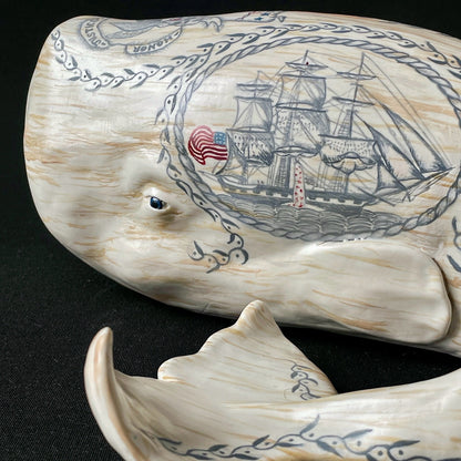 Porcelain Sperm whale sculpture with hand-painted scrimshaw design.  American maritime folk art.