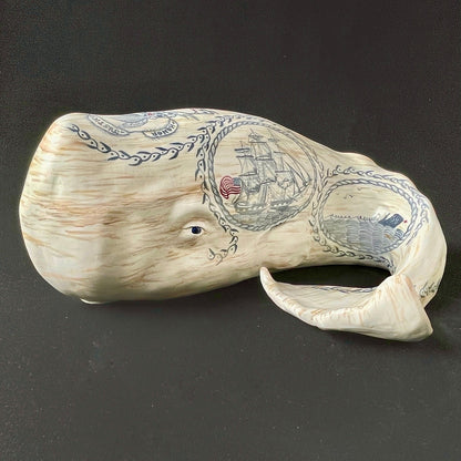 Whale sculpture with scrimshaw design.  Americana marine folk art.