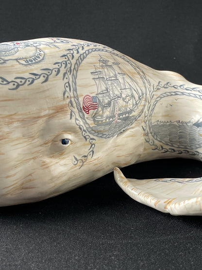 Sperm whale sculpture with hand-painted scrimshaw design.  American maritime art.