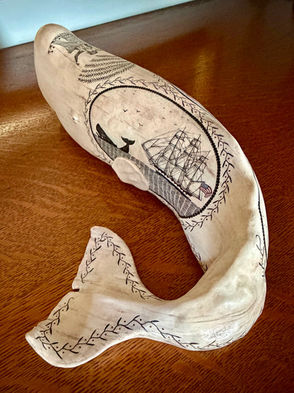 American contemporary folk art by Laura Rotelli.   Porcelain sperm whale sculpture with painted scrimshaw designs of sailing ships and whaling scenes, coastal maritime nautical artwork.