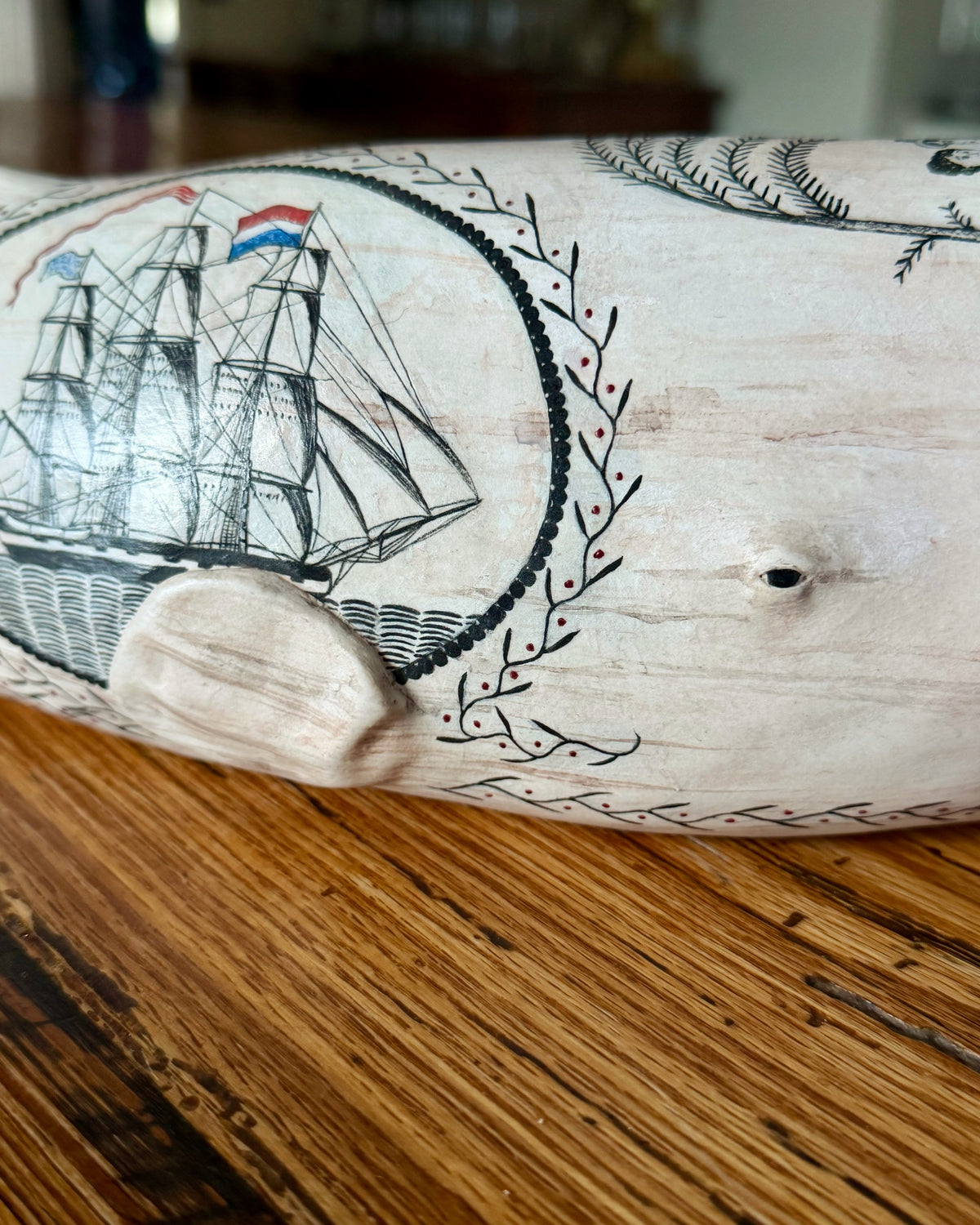Close-up of Edward II's sailing-ship panel, raised flipper, and surrounding leafy borders.
