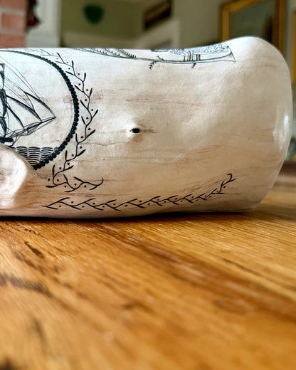 American contemporary folk art by Laura Rotelli.   Porcelain sperm whale sculpture with painted scrimshaw designs of sailing ships and whaling scenes, coastal maritime nautical artwork.