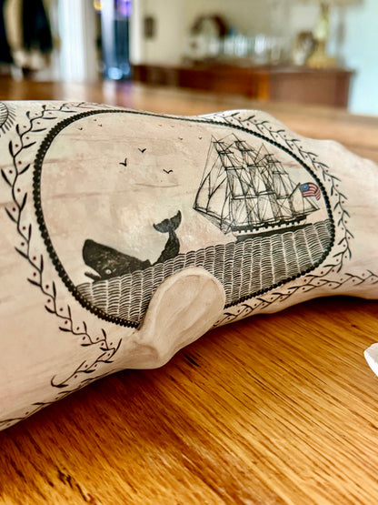 American contemporary folk art by Laura Rotelli.   Porcelain sperm whale sculpture with painted scrimshaw designs of sailing ships and whaling scenes, coastal maritime nautical artwork.