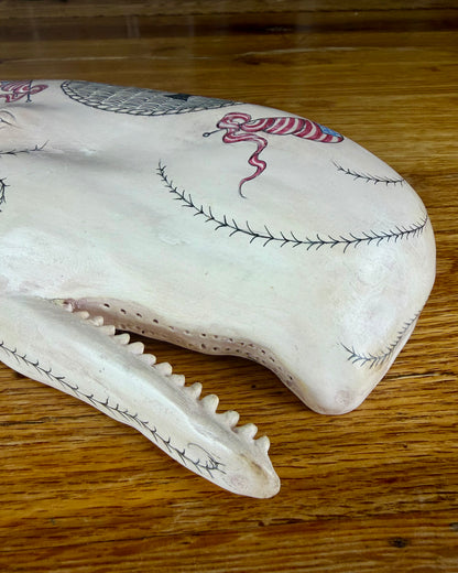 Hanging sperm whale sculpture by Laura Rotelli.  Sperm whale porcelain sculpture with scrimshaw designs of whaling scenes and ships painted on the surface.  Maritime art, marine art, folk art, Americana, patriotic art