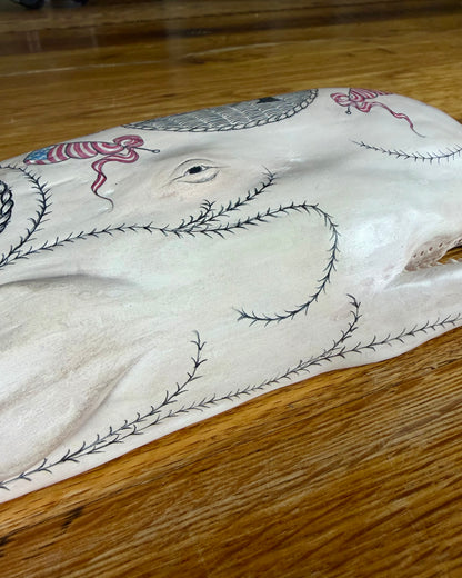 Hanging sperm whale sculpture by Laura Rotelli.  Sperm whale porcelain sculpture with scrimshaw designs of whaling scenes and ships painted on the surface.  Maritime art, marine art, folk art, Americana, patriotic art