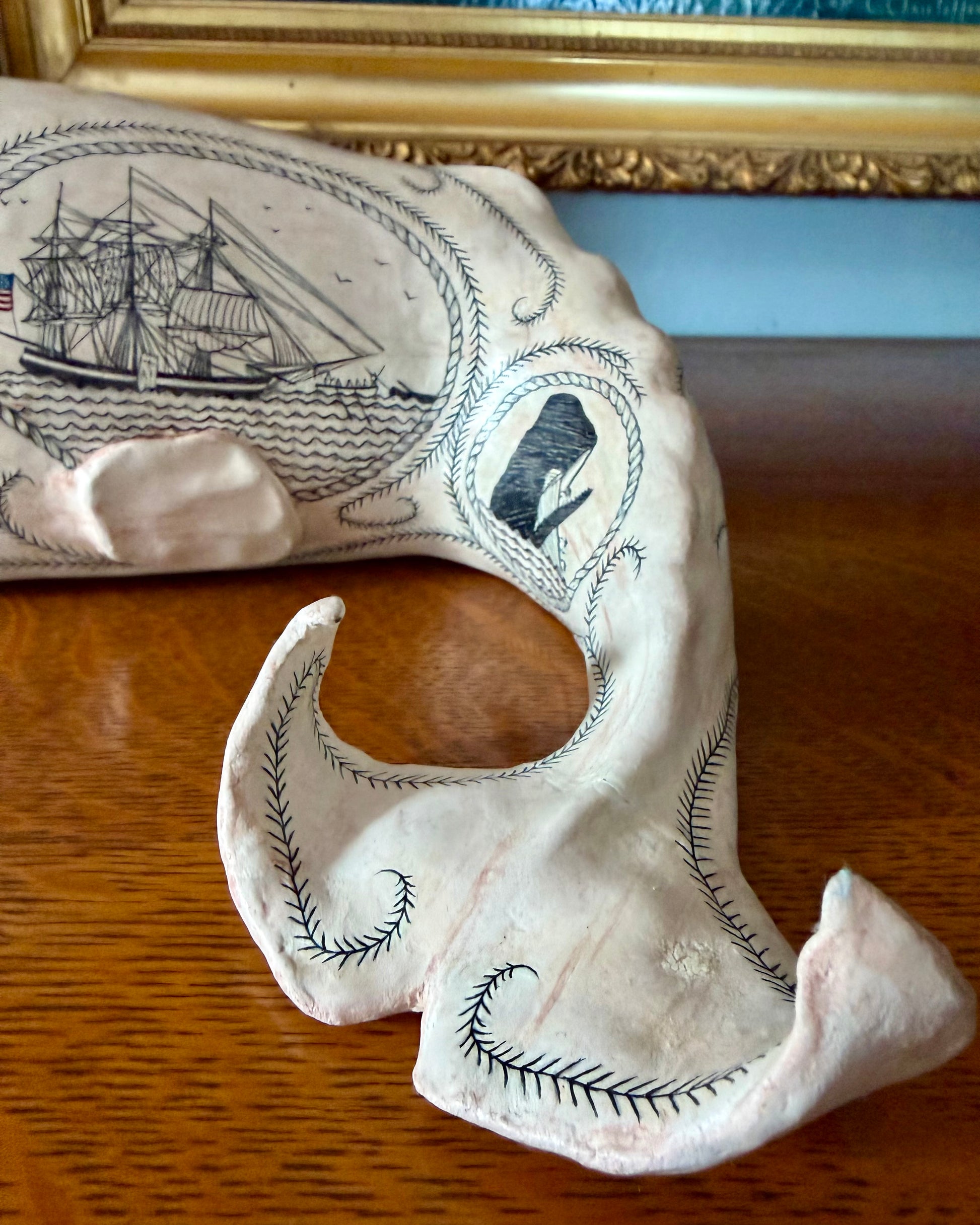 Sperm whale sculpture with scrimshaw design.  American maritime art.