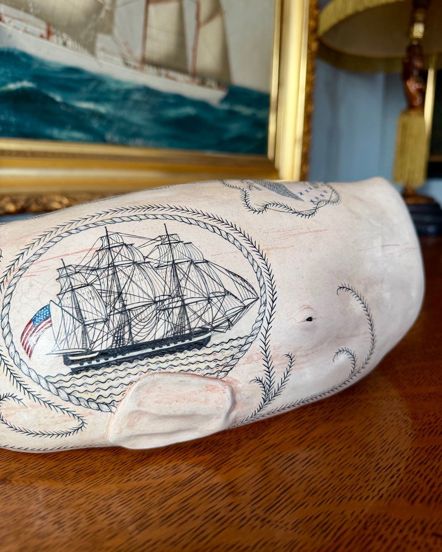 Sperm whale sculpture with scrimshaw design.  American maritime art.