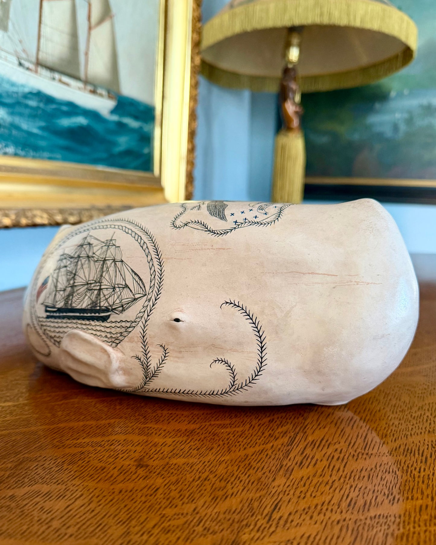 Sperm whale sculpture with scrimshaw design.  American maritime art.