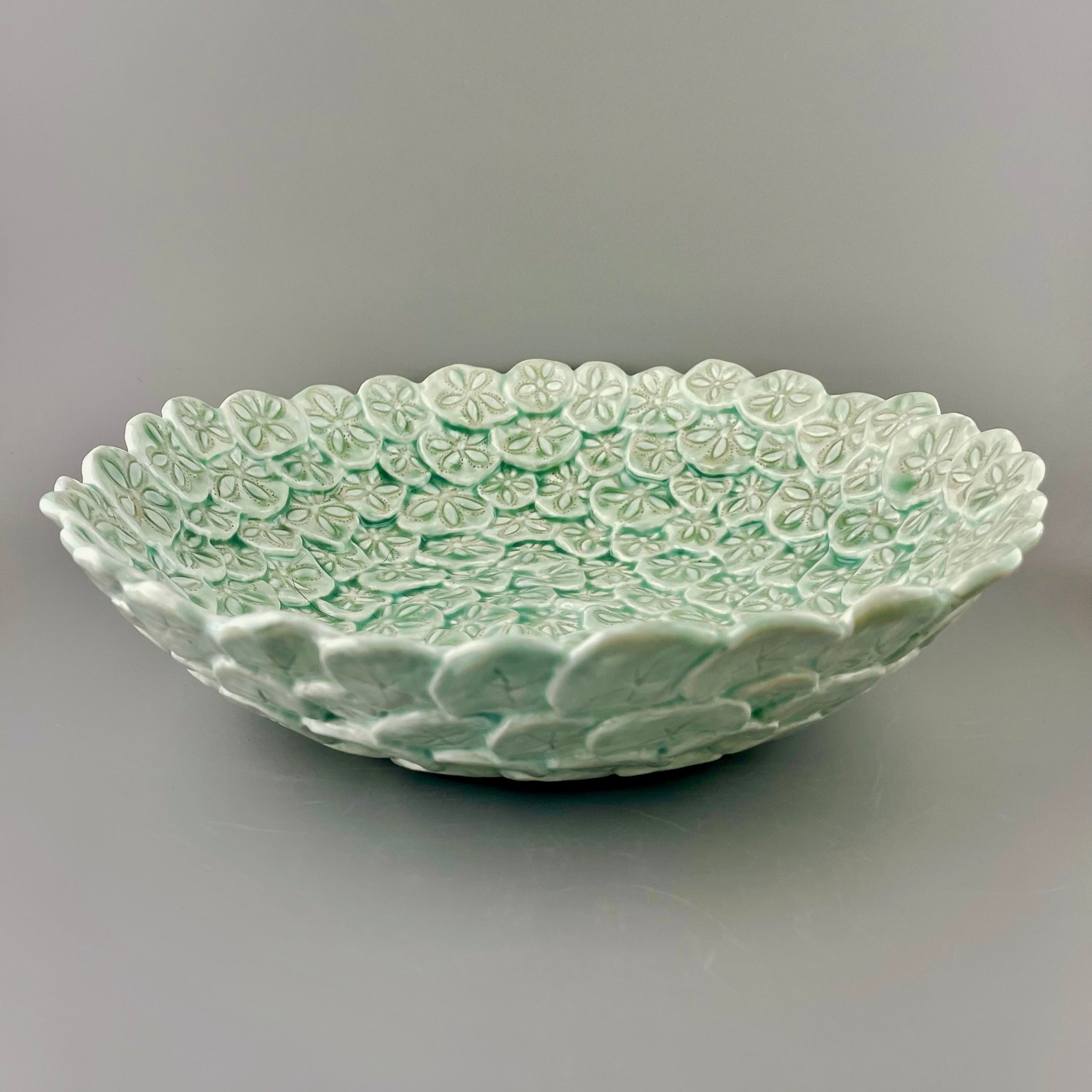 Hand-crafted porcelain bowl with sand dollars