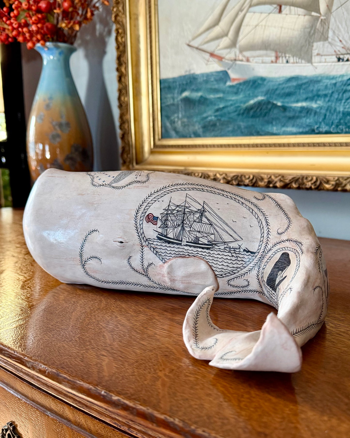 Sperm whale sculpture with scrimshaw design by Laura Rotelli.  Iconic Americana Maritime artwork for nautical and coastal decor