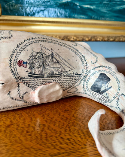 Sperm whale sculpture with scrimshaw design.  American maritime art.